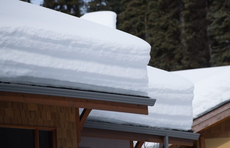 Heavy,Load,Of,White,Layered,Snow,On,Chalet,Roofs,Of
